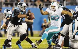  ?? MIKE MCCARN / ASSOCIATED PRESS ?? Dolphins defensive tackle Ndamukong Suh (93) has played well this season, but the rest of Miami’s $41.2 million defensive line has underwhelm­ed.