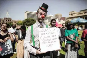  ?? GIANLUIGI GUERCIA/AFP ?? A man dressed up as a clown holds a placard during a rally outside the South African National Treasury on Monday in Pretoria called by ‘Save SA’, a coalition of civil organisati­ons, opposition parties, Unions members and supporters protesting against...