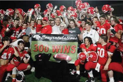  ?? MARK BUFFALO/THREE RIVERS EDITION ?? Cabot football coach Mike Malham, center, is surrounded by his family and players following the Panthers’ 41-21 win over Little Rock Central on Oct. 12 at Panther Stadium. The win was Malham’s 300th of his career, allowing him to join former Barton coach Frank McClellan, the only other high school coach in Arkansas to win at least 300 games.