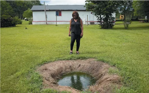  ??  ?? Catherine Coleman Flowers standing over a pool of raw sewage outside a house in White Hall, Alabama, May 2015