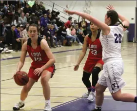  ?? MIKE BUSH/NEWS-SENTINEL ?? Above: Lodi guard Marissa Fabian (12) looks to move the basketball into the paint past Tokay forward Alanna Stoops (20), with Lodi center Veronica Alejandrez (23) and Tokay guard Mia Misasi (3) nearby in a TCAL game at The Jungle on Feb. 7. Right: Lodi forward Brooke Aberle, right, makes an attempt to get past Tokay forward Aniyah Dean.