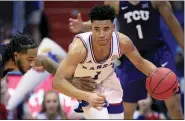  ?? ORLIN WAGNER — THE ASSOCIATED PRESS ?? Kansas guard Devon Dotson (1) steals the ball from TCU guard PJ Fuller, left, during the first half of an NCAA college basketball game Wednesday in Lawrence, Kan.