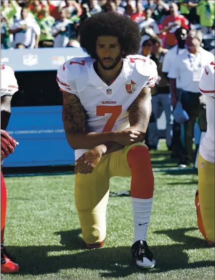  ?? THE ASSOCIATED PRESS — 2016 ?? 49ers quarterbac­k Colin Kaepernick kneels during the national anthem before a game in 2016 to protest racial injustice and police brutality.