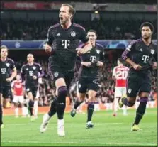  ?? ?? Harry Kane ( in front) was on target as Arsenal, Bayern Munich play 2-2 draw at Emirates Stadium in London on Tuesday night