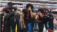  ??  ?? THEARON W. HENDERSON / GETTY IMAGES FILES Colin Kaepernick, centre, became a lightning rod of controvers­y last season in San Francisco for refusing to stand for the national anthem to protest police violence.