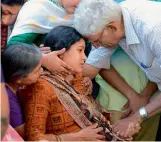  ?? — AFP ?? Sunayana Dumala, wife of Srinivas Kuchibhotl­a, consoled by family members prior to performing the last rites at his funeral in Hyderabad on Tuesday.