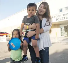  ?? LIAM RICHARDS ?? Pelican Narrows resident Ronalda Sewap with daughter Rankle, 4, and son Ramiro, 3, has been staying at the emergency evacuation shelter set up at the Henk Ruys Soccer Centre in Saskatoon.