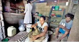  ??  ?? Nirmala Krishanthi hard at work in her home and above- the clay pots ready for sale. Pix by M.A. Pushpa Kumara