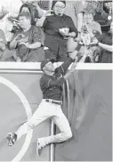  ?? ERIC CHRISTIAN SMITH/AP ?? Indians outfielder Greg Allen robs the Astros’ Alex Bregman of a homer during the first inning of a game last season.