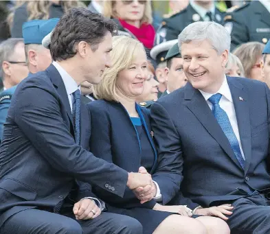  ?? WAYNE CUDDINGTON / POSTMEDIA NEWS FILES ?? Justin Trudeau shakes hands with Stephen Harper, with Laureen Harper in between, at a memorial service at the National War Memorial on Oct. 22, 2015, the one-year anniversar­y of the attack on Parliament Hill.