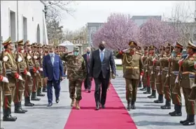  ?? Presidenti­al Palace via Associated Press ?? U.S. Defense Secretary Lloyd Austin, center, walks on the red carpet with Acting Afghan Minister of Defense Yasin Zia as they review an honor guard at the presidenti­al palace in Kabul, Afghanista­n, on Sunday.