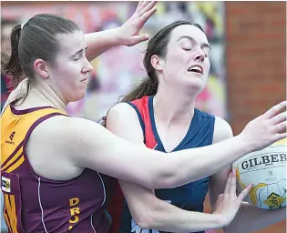  ?? Photograph­s by CRAIG JOHNSON. ?? Left: Drouin defender Kym Diston tangles with Bairnsdale’s Sally Dellerin the A grade game.