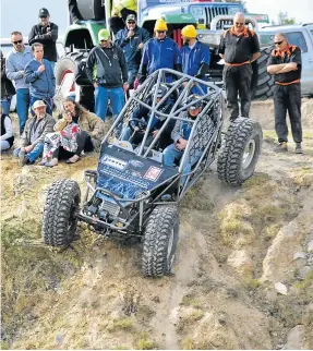  ??  ?? GOING DOWN: Spectators look on as a driver and his navigator contend with the scarily steep descent at the Bathurst Quarry