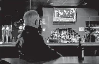  ?? TIM KROCHAK/SALTWIRE NETWORK ?? A man watches the television coverage of the U.S. election, at Dooley's in Halifax Wednesday, Nov. 4.