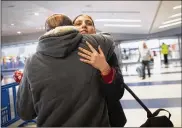  ??  ?? Mohammed Hafar hugs his daughter Jana after she arrives at JFK Airport in New York. Advocates say the process for obtaining a travel ban waiver is still shrouded in unpredicta­bility, which causes delays for thousands of American citizens waiting for loved ones.