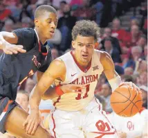  ?? GARETT FISBECK/ASSOCIATED PRESS ?? Oklahoma’s Trae Young (11) drives the ball past Texas Tech’s Jarrett Culver (23) during Tuesday night’s game. Young scored 27 points as the Sooners won 75-65.