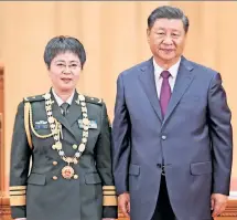  ??  ?? TROUBLING: President Xi Jinping presents a medal in September to General Chen Wei, the nation’s top biowar expert, who was suspicious­ly dispatched to Wuhan (lab at left) at the start of the outbreak that President Biden still says could have stemmed from animal-to-human contact.