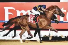  ?? Virendra Saklani/Gulf News ?? Trinity Force, ridden by Tadhg O’Shea, wins the featured Emirates Airlines Handicap at Meydan.