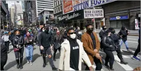  ??  ?? Protesters march past the Winter Garden Theatre in Times Square in New York on April 22, 2021, during a rally of theater workers demanding more inclusion for minorities and the disabled.