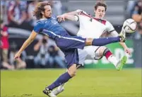  ?? Simon Hofmann Bongar ts/Getty Images ?? SEBASTIAN RUDY of Germany and Mix Diskerud, left, of the U.S. battle for the ball. Diskerud had a goal in the game.