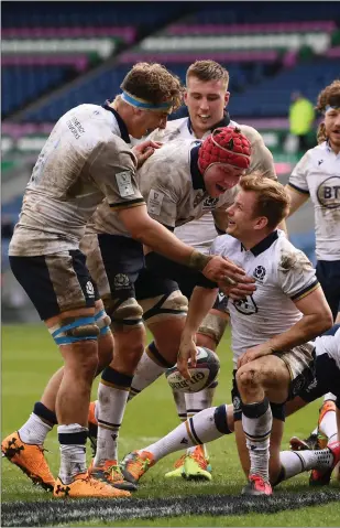  ??  ?? Scott Steele celebrates with his Scotland team-mates after scoring their sixth try in the 52-10 mauling of Italy