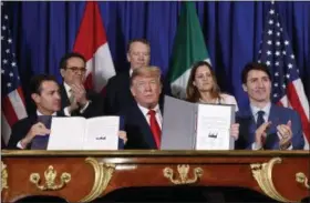  ?? AP PHOTO/ PABLO MARTINEZ MONSIVAIS ?? President Donald Trump, Canada’s Prime Minister Justin Trudeau, right, and Mexico’s President Enrique Pena Neto, left, participat­e in the USMCA signing ceremony Friday in Buenos Aires, Argentina.