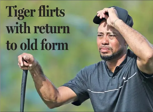  ??  ?? Tiger Woods adjusts his cap on the 10th green during Thursday’s opening round of the Hero World Challenge in Nassau, Bahamas. After a strong start, Woods carded a 73 in his first competitiv­e tournament in 16 months.