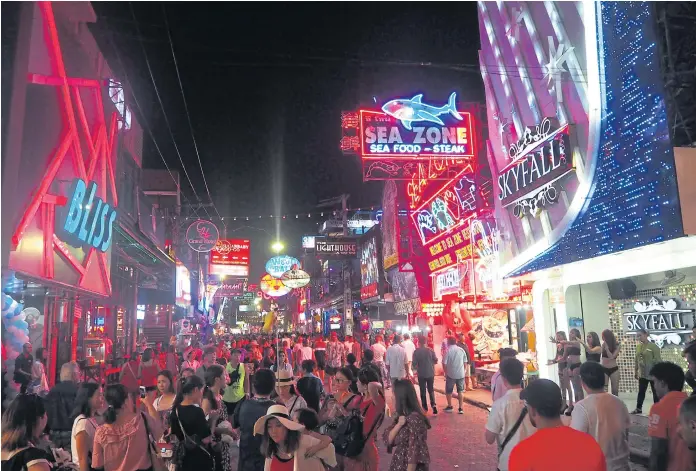  ??  ?? WHERE THE ACTION IS: Visitors swarm the streets of Pattaya day and night. Among the most popular tourist spots is Walking Street.