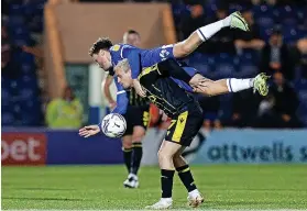  ?? ?? Colchester United’s Noah Chilvers climbs all over Rovers’ Luke Thomas