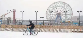  ?? MARY ALTAFFER, AP ?? The snowfall at New York’s Coney Island on Friday was little compared with what blizzard conditions could bring lateMonday.