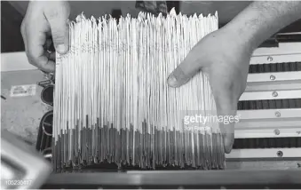  ?? JOE RAEDLE Getty Images ?? Julio Galligaris sorts through mail-in ballots that have been cast and received at the Miami-Dade Election Department headquarte­rs in October.