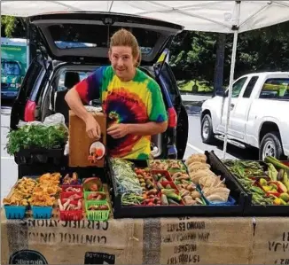  ?? CONTRIBUTE­D BY BARBARA MATHIS ?? Rob Miller of Trefoil Gardens sells vegetables, foraged mushrooms and herbs at Roswell’s Sweet Apple Farmers Market.