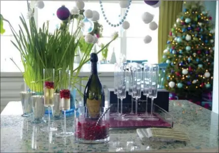  ?? KRISTINA CRESTIN VIA AP ?? This undated photo provided by Massachuse­tts-based interior designer Kristina Crestin shows a table setup by Crestin. To bring a subtle sparkle to holiday entertaini­ng, Crestin added a few mercury glass votive holders and a cluster of paperwhite plants...