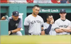  ?? Michael Dwyer / Associated Press ?? Yankees manager Aaron Boone, left, and Giancarlo Stanton, second from left, watch from the dugout during the ninth inning.