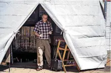  ?? [PHOTO BY CHRIS LANDSBERGE­R, THE OKLAHOMAN] ?? Rory Morgan, of Edmond, prepares his tent as he sets up Monday for the 2018 Festival of the Arts at Bicentenni­al Park in Oklahoma City.