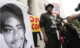  ??  ?? Cephus ‘Bobby’ Johnson stands in protest of the release of Johannes Mehserle, the transit officer who fatally shot his nephew Oscar Grant in 2009. Photograph: Nick Ut/AP