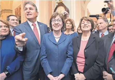  ?? J. SCOTT APPLEWHITE/AP ?? After a procedural vote aimed at reopening the government, lawmakers praise Sen. Susan Collins, R-Maine, on Monday for leading a bipartisan effort to get a spending measure passed.