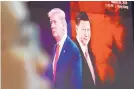  ?? AHN YOUNG-JOON/ASSOCIATED PRESS ?? A computer screen shows images of Chinese President Xi Jinping and U.S. President Donald Trump as a currency trader works in South Korea.