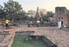  ??  ?? FANTASY FUN: Fans of TV series ‘Buppaesann­ivas’ wear traditiona­l attire at Wat Chai Wattanaram in Ayutthaya, which has seen a surge in tourism since the series aired.