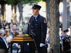  ?? Gabriela Bhaskar / New York Times ?? A bell rings during a ceremony Saturday marking the 20th anniversar­y of the Sept. 11, 2001 terrorist attacks, at the National September 11 Memorial and Museum in New York.