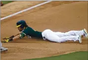  ?? MATT YORK — THE ASSOCIATED PRESS ?? The Athletics’ Chad Pinder dives in safely with a triple during the fourth inning of a spring training game Tuesday against the Colorado Rockies in Mesa, Ariz.