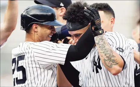  ?? Adam Hunger / Associated Press ?? The Yankees’ Gleyber Torres, left, congratula­tes Gary Sanchez after a walk-off single against the Twins during the 10th inning on Monday in New York. The Yankees won 6-5.