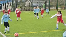  ??  ?? Arran United players look on as their team mate launches the ball past a St Cadoc’s defender.