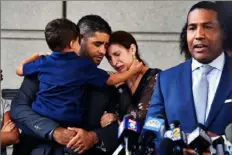  ?? James Keivom/ New York Times ?? Juan Rodriguez stands with his wife and son as his attorney, Joey Jackson, speaks to reporters Aug. 1, 2019, outside a courthouse in the Bronx, N.Y. Mr. Rodriguez reached a plea agreement on Wednesday after being charged in the death of his infant twins, who died in a hot car.