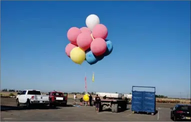  ?? PHOTO COURTESY OF YOUNG’S COMMERCIAL TRANSFER ?? David Blaine’s balloons after landing at Young’s Commercial Transfer’s parking lot on Friday, August 14.