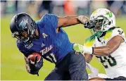  ?? [AP PHOTO] ?? Tulsa’s Nigel Carter, left, beats South Florida’s Devin Abraham for a first-down catch during a Nov. 16 game in Tampa. TU plays its final home game of the season Saturday against Temple.