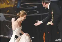  ??  ?? ACTRESS Jennifer Lawrence is helped by presenter French actor Jean Dujardin after she tripped walking up the stairs to accept the award for best actress for her role in Silver Linings Playbook at the 85th Academy Awards in Hollywood, California on Feb....