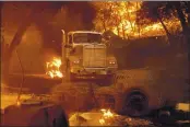  ?? NOAH BERGER — THE ASSOCIATED PRESS ?? Flames from tHe Glass Fire burn a truck in a Calistoga vineyard on THursday.