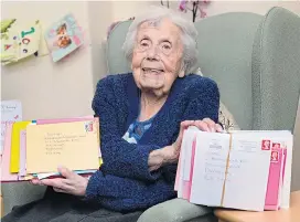  ?? Picture: SWNS ?? Delighted Lizzie with some of the 638 birthday cards sent by strangers