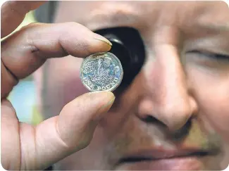  ??  ?? A close look at the thinner, lighter new £1 coin, to be introduced this week.